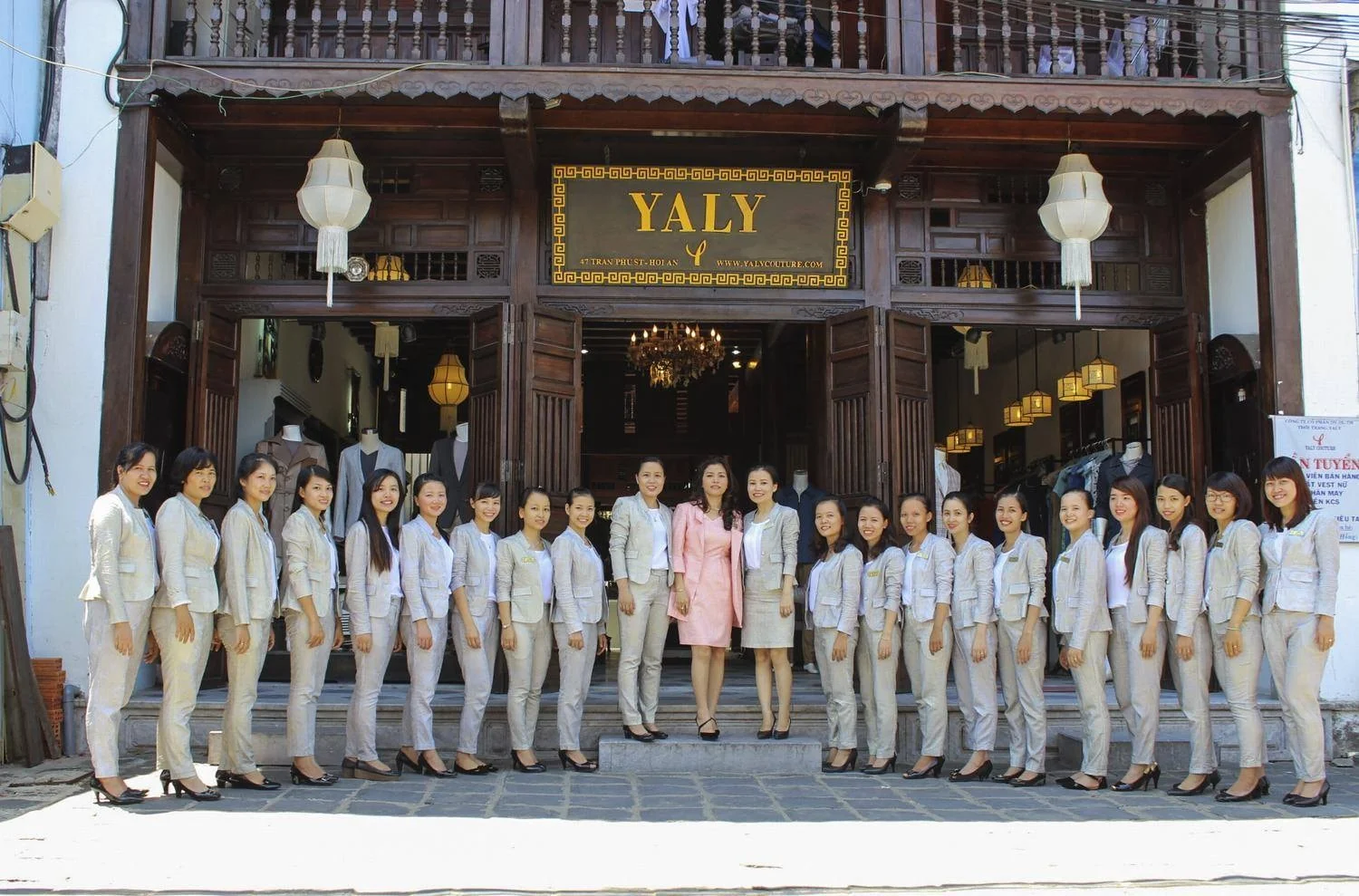 Tailor measuring a guest inside a Hội An atelier