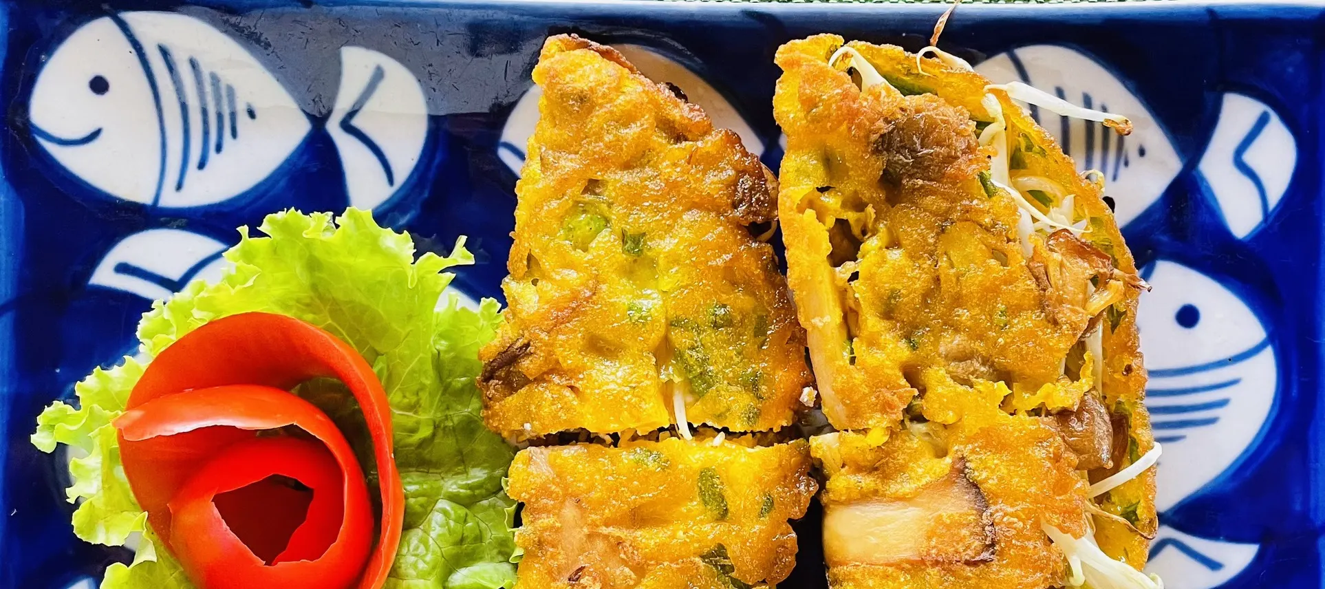 Guests searing bánh xèo in hot pans